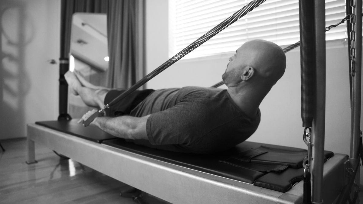 West Hollywood Pilates founder, Yonatan Elkayam, practicing the Pilates hundreds on the tower, exemplifying the private one-on-one sessions at our Pilates and wellness studio in West Hollywood.