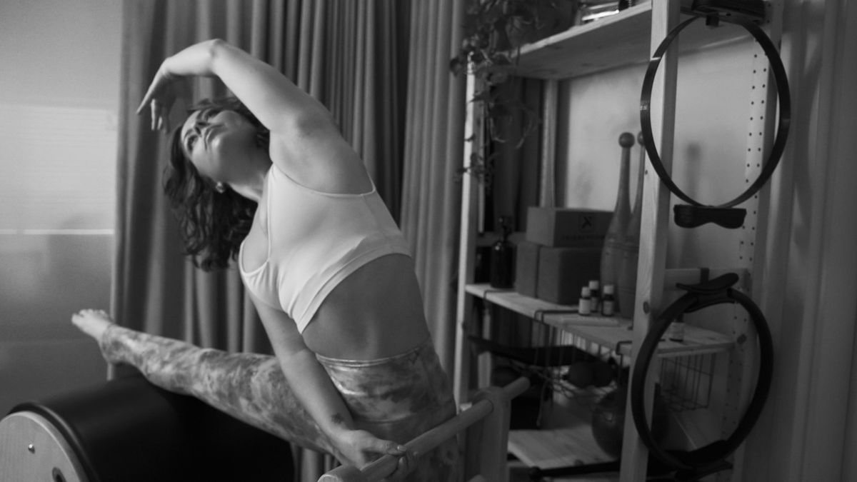 A person performing a Pilates exercise focused on balance, showcasing stability and core engagement.